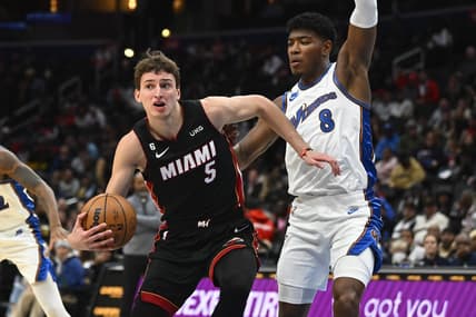 Nov 18, 2022; Washington, District of Columbia, USA; Miami Heat forward Nikola Jovic (5) looks to pass as Washington Wizards forward Rui Hachimura (8) defends during the first half at Capital One Arena. Mandatory Credit: Brad Mills-USA TODAY Sports