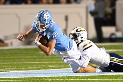 Nov 19, 2022; Chapel Hill, North Carolina, USA; North Carolina Tar Heels quarterback Drake Maye (10) is tackled by Georgia Tech Yellow Jackets linebacker Charlie Thomas (1) in the first quarter at Kenan Memorial Stadium. Mandatory Credit: Bob Donnan-USA TODAY Sports