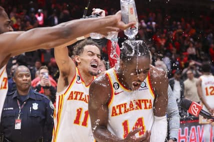 Nov 19, 2022; Atlanta, Georgia, USA; Atlanta Hawks guard Trae Young (11) dumps water on forward AJ Griffin (14) after an overtime victory against the Toronto Raptors at State Farm Arena. Mandatory Credit: Brett Davis-USA TODAY Sports