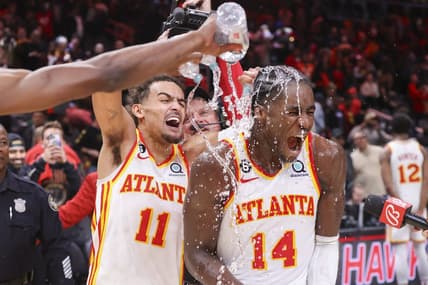 Nov 19, 2022; Atlanta, Georgia, USA; Atlanta Hawks guard Trae Young (11) dumps water on forward AJ Griffin (14) after an overtime victory against the Toronto Raptors at State Farm Arena. Mandatory Credit: Brett Davis-USA TODAY Sports