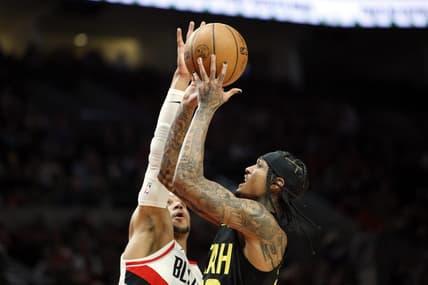 Nov 19, 2022; Portland, Oregon, USA; Utah Jazz point guard Jordan Clarkson (00) shoots the ball against Portland Trail Blazers shooting guard Josh Hart (11, left) during the first half at Moda Center. Mandatory Credit: Soobum Im-USA TODAY Sports
