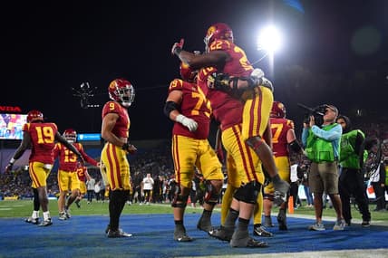 Nov 19, 2022; Pasadena, California, USA; Southern California Trojans running back Darwin Barlow (22) celebrates his touchdown scored against the UCLA Bruins with offensive lineman Bobby Haskins (70) during the second half at the Rose Bowl. Mandatory Credit: Gary A. Vasquez-USA TODAY Sports