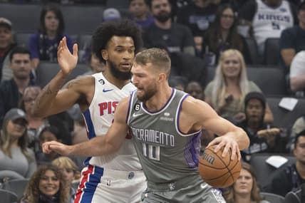 November 20, 2022; Sacramento, California, USA; Sacramento Kings forward Domantas Sabonis (10) dribbles the basketball against Detroit Pistons forward Marvin Bagley III (35) during the first quarter at Golden 1 Center. Mandatory Credit: Kyle Terada-USA TODAY Sports