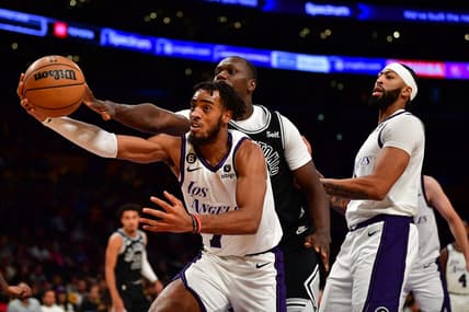 Nov 20, 2022; Los Angeles, California, USA; Los Angeles Lakers forward Troy Brown Jr. (7) plays for the rebound againt San Antonio Spurs center Gorgui Dieng (41) during the first half at Crypto.com Arena. Mandatory Credit: Gary A. Vasquez-USA TODAY Sports
