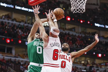 Nov 21, 2022; Chicago, Illinois, USA; Boston Celtics forward Jayson Tatum (0) is defended by Chicago Bulls guard Alex Caruso (6) and guard Coby White (0) during the second half at United Center. Mandatory Credit: Kamil Krzaczynski-USA TODAY Sports