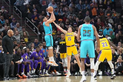 Nov 22, 2022; Phoenix, Arizona, USA; Phoenix Suns guard Devin Booker (1) shoots over Los Angeles Lakers guard Austin Reaves (15) during the first half at Footprint Center. Mandatory Credit: Joe Camporeale-USA TODAY Sports