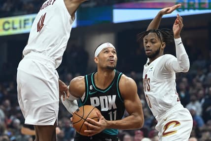 Nov 23, 2022; Cleveland, Ohio, USA; Portland Trail Blazers guard Josh Hart (11) drives to the basket between Cleveland Cavaliers forward Evan Mobley (4) and guard Darius Garland (10) during the first half at Rocket Mortgage FieldHouse. Mandatory Credit: Ken Blaze-USA TODAY Sports
