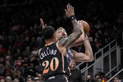 Nov 23, 2022; Atlanta, Georgia, USA; Sacramento Kings forward Domantas Sabonis (10) tries to shoot guarded by Atlanta Hawks forward John Collins (20) during the first half at State Farm Arena. Mandatory Credit: Dale Zanine-USA TODAY Sports