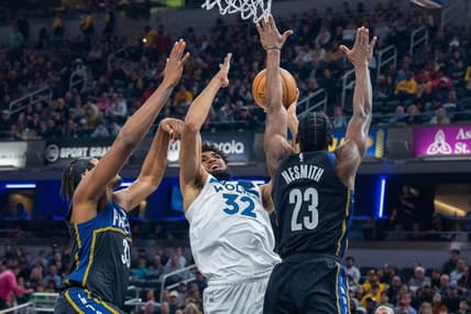 Nov 23, 2022; Indianapolis, Indiana, USA; Minnesota Timberwolves center Karl-Anthony Towns (32) shoots the ball while Indiana Pacers forward Aaron Nesmith (23) defends in the second quarter at Gainbridge Fieldhouse. Mandatory Credit: Trevor Ruszkowski-USA TODAY Sports