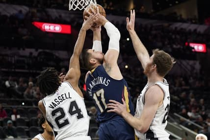 Nov 23, 2022; San Antonio, Texas, USA; New Orleans Pelicans center Jonas Valanciunas (17) shoots over San Antonio Spurs guard Devin Vassell (24) and center Jakob Poeltl (25) during the first half at AT&T Center. Mandatory Credit: Scott Wachter-USA TODAY Sports
