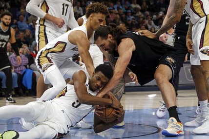 Nov 25, 2022; Memphis, Tennessee, USA; New Orleans Pelicans guard Dyson Daniels (11) forward Herbert Jones (5) and Memphis Grizzlies center Steven Adams (4) battle for a loose ball during the first half at FedExForum. Mandatory Credit: Petre Thomas-USA TODAY Sports