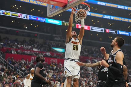 Nov 25, 2022; Los Angeles, California, USA; Denver Nuggets forward Aaron Gordon (50) dunks the ball against LA Clippers guard Reggie Jackson (1) and center Ivica Zubac (40) in the first half at Crypto.com Arena. Mandatory Credit: Kirby Lee-USA TODAY Sports