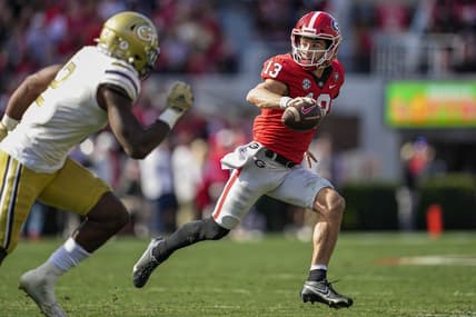 Nov 26, 2022; Athens, Georgia, USA; Georgia Bulldogs quarterback Stetson Bennett (13) runs with the ball against the Georgia Tech Yellow Jackets during the first quarter at Sanford Stadium. Mandatory Credit: Dale Zanine-USA TODAY Sports
