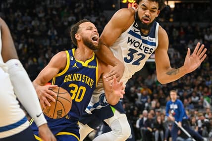 Nov 27, 2022; Minneapolis, Minnesota, USA; Golden State Warriors guard Stephen Curry (30) is called for traveling on this play with Minnesota Timberwolves center Karl-Anthony Towns (32) during the second quarter at Target Center. Mandatory Credit: Nick Wosika-USA TODAY Sports