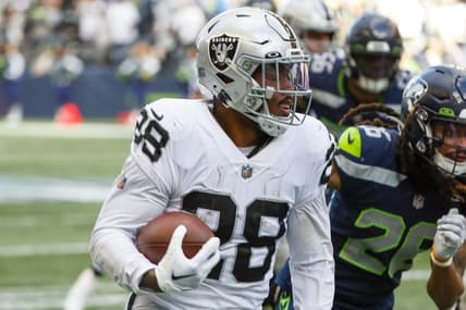 Nov 27, 2022; Seattle, Washington, USA; Las Vegas Raiders running back Josh Jacobs (28) rushes fora touchdown against the Seattle Seahawks during the second quarter at Lumen Field. Mandatory Credit: Joe Nicholson-USA TODAY Sports