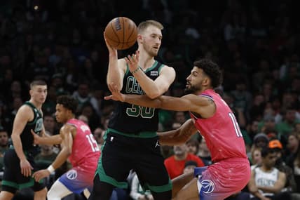 Nov 27, 2022; Boston, Massachusetts, USA; Boston Celtics forward Sam Hauser (30) looks to pass around Washington Wizards forward Anthony Gill (16) during the second half at TD Garden. Mandatory Credit: Winslow Townson-USA TODAY Sports