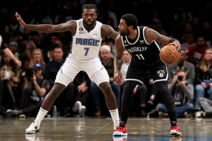 Nov 28, 2022; Brooklyn, New York, USA; Brooklyn Nets guard Kyrie Irving (11) controls the ball against Orlando Magic guard Kevon Harris (7) during the first quarter at Barclays Center. Mandatory Credit: Brad Penner-USA TODAY Sports