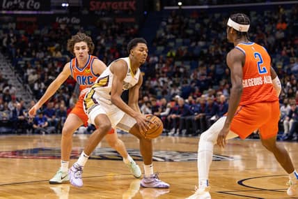 Nov 28, 2022; New Orleans, Louisiana, USA; New Orleans Pelicans guard Trey Murphy III (25) dribbles against Oklahoma City Thunder guard Josh Giddey (3) and guard Shai Gilgeous-Alexander (2) during the first half at Smoothie King Center. Mandatory Credit: Stephen Lew-USA TODAY Sports