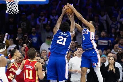 Nov 28, 2022; Philadelphia, Pennsylvania, USA; Philadelphia 76ers center Joel Embiid (21) gains control of the ball in front of Atlanta Hawks guard Trae Young (11) and forward John Collins (20) in the closing seconds of the fourth quarter at Wells Fargo Center. Mandatory Credit: Bill Streicher-USA TODAY Sports
