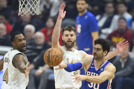 Nov 30, 2022; Cleveland, Ohio, USA; Philadelphia 76ers guard Furkan Korkmaz (30) throws a pass against Cleveland Cavaliers forward Evan Mobley (4) and forward Dean Wade (32) in the first quarter at Rocket Mortgage FieldHouse. Mandatory Credit: David Richard-USA TODAY Sports