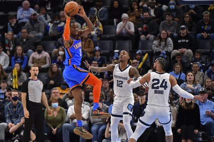Dec 20, 2021; Memphis, Tennessee, USA; Oklahoma City Thunder guard Shai Gilgeous-Alexander (2) looks to pass against Memphis Grizzlies guard Ja Morant (12) during the second half at FedExForum. Mandatory Credit: Justin Ford-USA TODAY Sports
