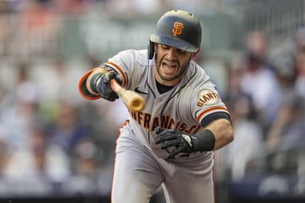 Jun 21, 2022; Cumberland, Georgia, USA; San Francisco Giants designated hitter Tommy La Stella (8) reacts after being hit by a pitch prior to scoring against the Atlanta Braves during the second inning at Truist Park. Mandatory Credit: Dale Zanine-USA TODAY Sports