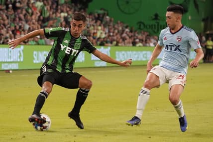Jun 25, 2022; Austin, Texas, USA; Austin FC midfielder Hector Jimenez (16) keeps the ball away from FC Dallas forward Alan Velasco (20) in the first half at Q2 Stadium. Mandatory Credit: Scott Wachter-USA TODAY Sports
