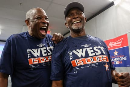 Sep 19, 2022; St. Petersburg, Florida, USA;  Houston Astros manager Dusty Baker Jr. (12) and third base coach Gary Pettis (8) celebrate winning the American League West at Tropicana Field. Mandatory Credit: Nathan Ray Seebeck-USA TODAY Sports