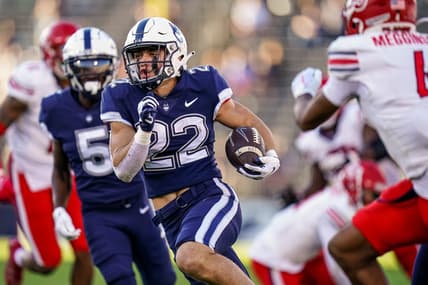 Nov 12, 2022; East Hartford, Connecticut, USA; Connecticut Huskies running back Victor Rosa (22) runs the ball for a touchdown against the Liberty Flames in the second half at Rentschler Field at Pratt & Whitney Stadium. Mandatory Credit: David Butler II-USA TODAY Sports