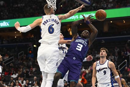 Nov 20, 2022; Washington, District of Columbia, USA; Washington Wizards center Kristaps Porzingis (6) blocks the shot of Charlotte Hornets guard Terry Rozier (3) during the second half at Capital One Arena. Mandatory Credit: Brad Mills-USA TODAY Sports