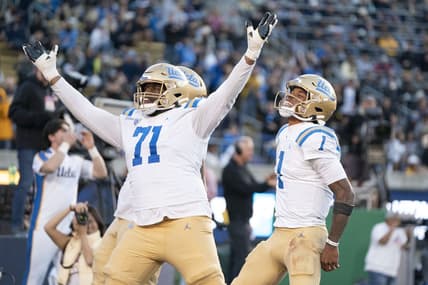 November 25, 2022; Berkeley, California, USA; UCLA Bruins offensive lineman Raiqwon O'Neal (71) and quarterback Dorian Thompson-Robinson (1) celebrate a two-point conversion against the California Golden Bears during the fourth quarter at California Memorial Stadium. Mandatory Credit: Kyle Terada-USA TODAY Sports