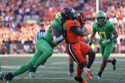 Nov 26, 2022; Corvallis, Oregon, USA; Oregon Ducks linebacker DJ Johnson (2) pushes Oregon State Beavers running back Jam Griffin (8) out of bounds during the first half at Reser Stadium. Mandatory Credit: Soobum Im-USA TODAY Sports
