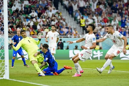 Nov 29, 2022; Doha, Qatar; United States of America forward Christian Pulisic (10) collides with Iran goalkeeper Alireza Beiranvand (1) after scoring a goal during the first half of a group stage during the 2022 World Cup at Al Thumama Stadium. Mandatory Credit: Danielle Parhizkaran-USA TODAY Sports