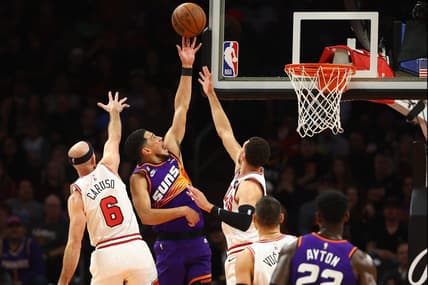 Nov 30, 2022; Phoenix, Arizona, USA; Phoenix Suns guard Devin Booker (1) shoots against Chicago Bulls guard Zach LaVine (8) and guard Alex Caruso (6) during the first half  at Footprint Center. Mandatory Credit: Mark J. Rebilas-USA TODAY Sports