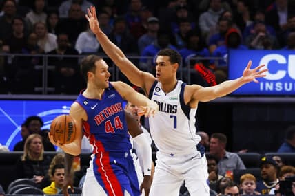 Dec 1, 2022; Detroit, Michigan, USA; Detroit Pistons forward Bojan Bogdanovic (44) is defended by Dallas Mavericks center Dwight Powell (7) in the first half at Little Caesars Arena. Mandatory Credit: Rick Osentoski-USA TODAY Sports