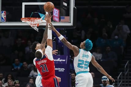 Dec 2, 2022; Charlotte, North Carolina, USA; Charlotte Hornets center Nick Richards (4) and forward Kai Jones (23) try for a block on Washington Wizards center Daniel Gafford (21) during the first quarter at Spectrum Center. Mandatory Credit: Jim Dedmon-USA TODAY Sports