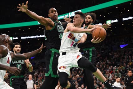 Dec 2, 2022; Boston, Massachusetts, USA; Miami Heat guard Tyler Herro (14) looks to pass the ball while Boston Celtics center Al Horford (42) defends during the first half at TD Garden. Mandatory Credit: Bob DeChiara-USA TODAY Sports