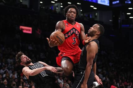 Dec 2, 2022; Brooklyn, New York, USA; Toronto Raptors forward O.G. Anunoby (3) draws a charge ob Brooklyn Nets forward Joe Harris (12) and forward T.J. Warren (1) during the first half at Barclays Center. Mandatory Credit: Vincent Carchietta-USA TODAY Sports