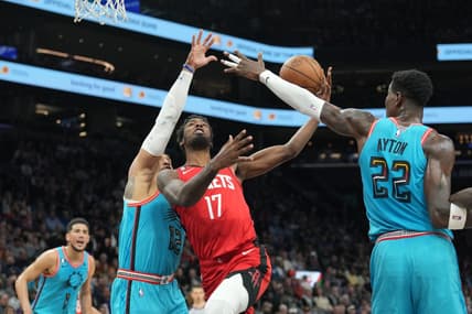 Dec 2, 2022; Phoenix, Arizona, USA; Houston Rockets forward Tari Eason (17) drives against Phoenix Suns forward Ish Wainright (12) and Phoenix Suns center Deandre Ayton (22) during the first half at Footprint Center. Mandatory Credit: Joe Camporeale-USA TODAY Sports