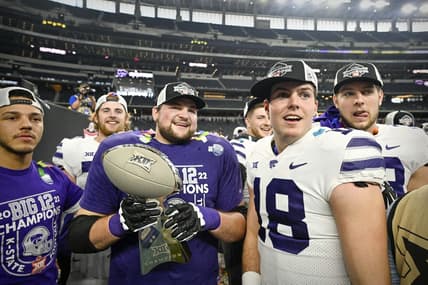 Dec 3, 2022; Arlington, TX, USA; Kansas State Wildcats quarterback Will Howard (18) and his teammates celebrate winning the Big 12 championship after defeating the TCU Horned Frogs in overtime at AT&T Stadium. Mandatory Credit: Jerome Miron-USA TODAY Sports