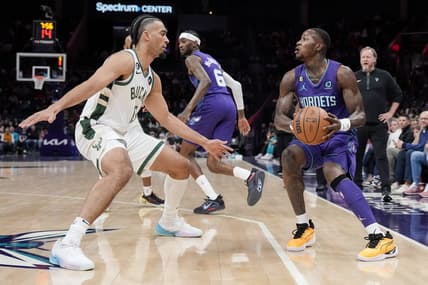 Dec 3, 2022; Charlotte, North Carolina, USA; Charlotte Hornets guard Terry Rozier (3) looks to shoot over Milwaukee Bucks forward Jordan Nwora (13) during the first half at the Spectrum Center. Mandatory Credit: Jim Dedmon-USA TODAY Sports