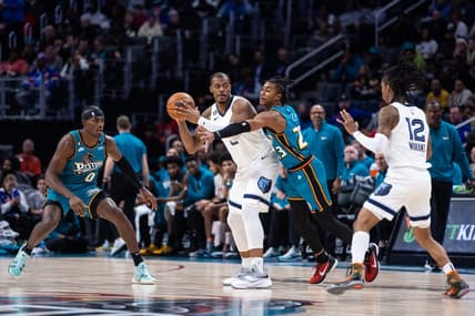 Dec 4, 2022; Detroit, Michigan, USA; Memphis Grizzlies forward Xavier Tillman Sr. (2) passes the ball through coverage by Detroit Pistons guard Jaden Ivey (23) in the first quarter at Little Caesars Arena. Mandatory Credit: Allison Farrand-USA TODAY Sports
