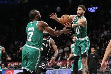 Dec 4, 2022; Brooklyn, New York, USA; Boston Celtics guard Jaylen Brown (7) and forward Jayson Tatum (0) reach for the ball in the fourth quarter  against the Brooklyn Nets at Barclays Center. Mandatory Credit: Wendell Cruz-USA TODAY Sports