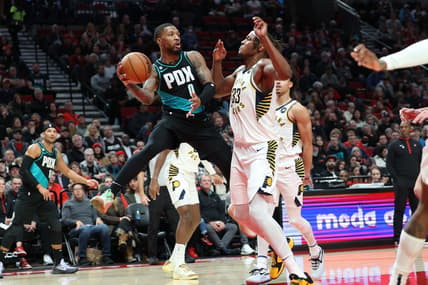 Dec 4, 2022; Portland, Oregon, USA; Portland Trail Blazers guard Damian Lillard (0) passes the ball around Indiana Pacers center Myles Turner (33) in the first half at Moda Center. Mandatory Credit: Jaime Valdez-USA TODAY Sports