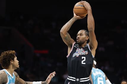 Dec 5, 2022; Charlotte, North Carolina, USA; Los Angeles Clippers forward Kawhi Leonard (2) shoots over Charlotte Hornets guard Kelly Oubre Jr. (12) during the second half at Spectrum Center. The Los Angeles Clippers won 119-117. at Spectrum Center. Mandatory Credit: Nell Redmond-USA TODAY Sports