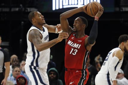 Dec 5, 2022; Memphis, Tennessee, USA; Miami Heat center Bam Adebayo (13) passes the ball as Memphis Grizzlies forward Xavier Tillman (2) defends during the second half at FedExForum. Mandatory Credit: Petre Thomas-USA TODAY Sports