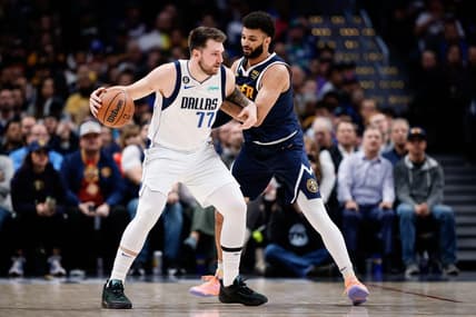 Dec 6, 2022; Denver, Colorado, USA; Dallas Mavericks guard Luka Doncic (77) controls the ball as Denver Nuggets guard Jamal Murray (27) guards in the second quarter at Ball Arena. Mandatory Credit: Isaiah J. Downing-USA TODAY Sports