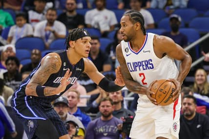 Dec 7, 2022; Orlando, Florida, USA; LA Clippers forward Kawhi Leonard (2) looks to pass in front of Orlando Magic forward Paolo Banchero (5) during the first quarter at Amway Center. Mandatory Credit: Mike Watters-USA TODAY Sports