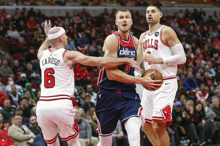 Dec 7, 2022; Chicago, Illinois, USA; Washington Wizards center Kristaps Porzingis (6) drives to the basket against Chicago Bulls guard Alex Caruso (6) during the first half at United Center. Mandatory Credit: Kamil Krzaczynski-USA TODAY Sports