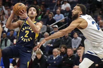 Dec 7, 2022; Minneapolis, Minnesota, USA; Indiana Pacers guard Andrew Nembhard (2) goes to the basket past Minnesota Timberwolves center Rudy Gobert (27) in the first quarter at Target Center. Mandatory Credit: Bruce Kluckhohn-USA TODAY Sports